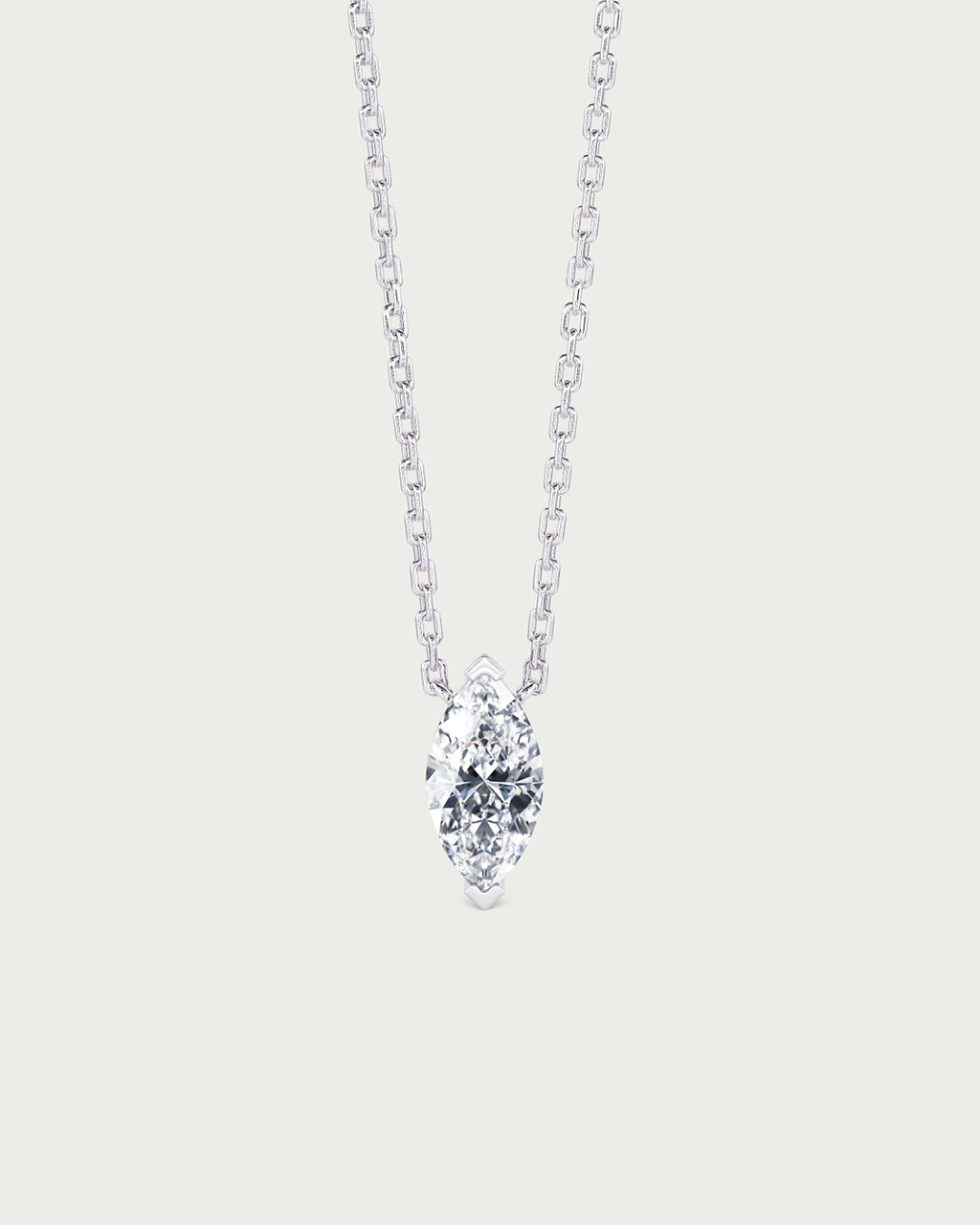 solo product shot of 18k white gold lab grown diamond marquise pendant necklace on off-white background