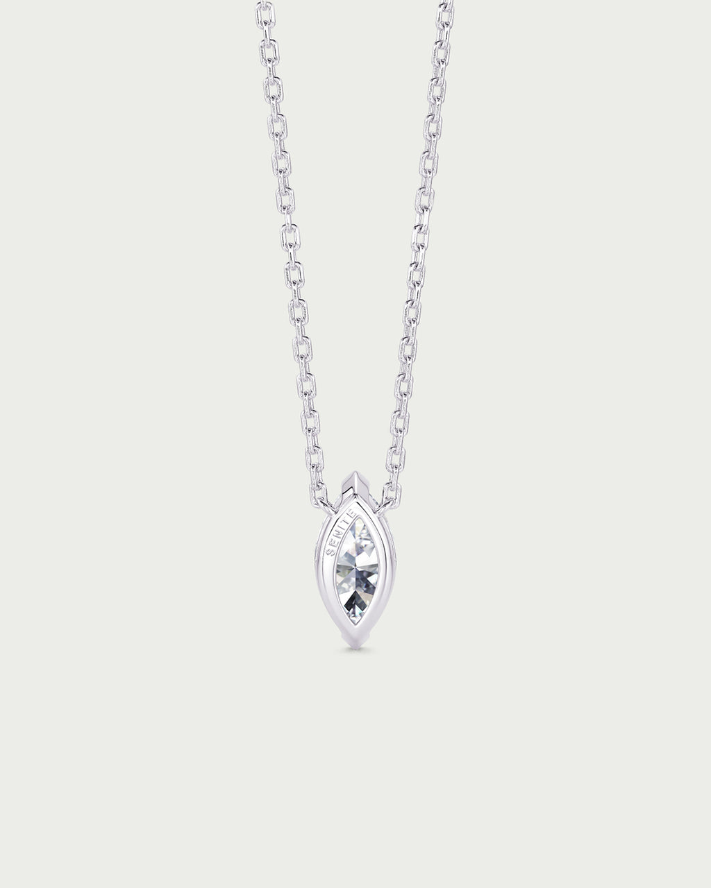 solo product shot of 18k white gold lab grown diamond marquise pendant necklace on off-white background