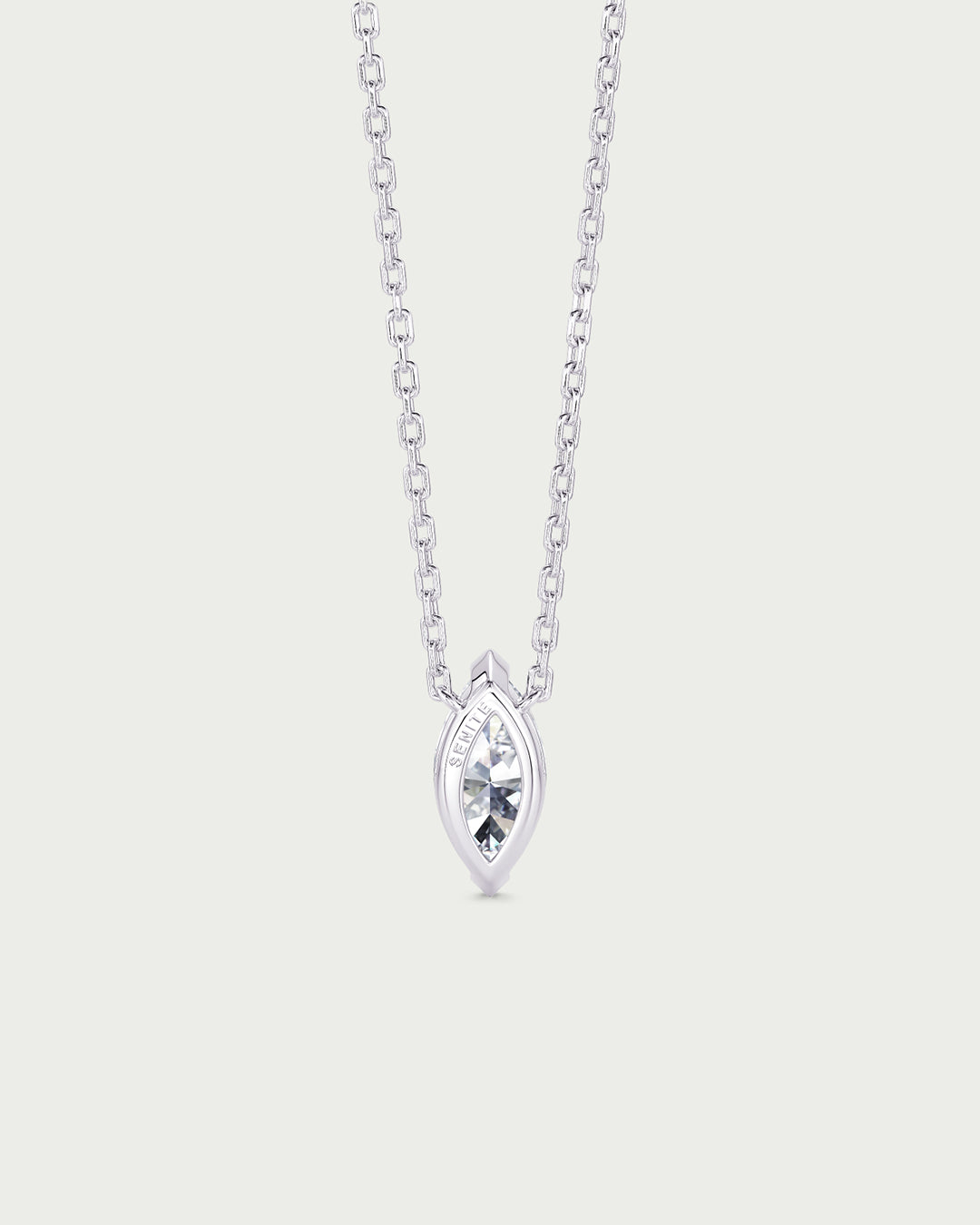 solo product shot of 18k white gold lab grown diamond marquise pendant necklace on off-white background